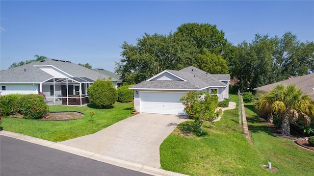 2821 Mediterranean Loop, Tavares, FL 32778 - view of front facade with a front yard, driveway, a garage, a shingled roof, and glass enclosure