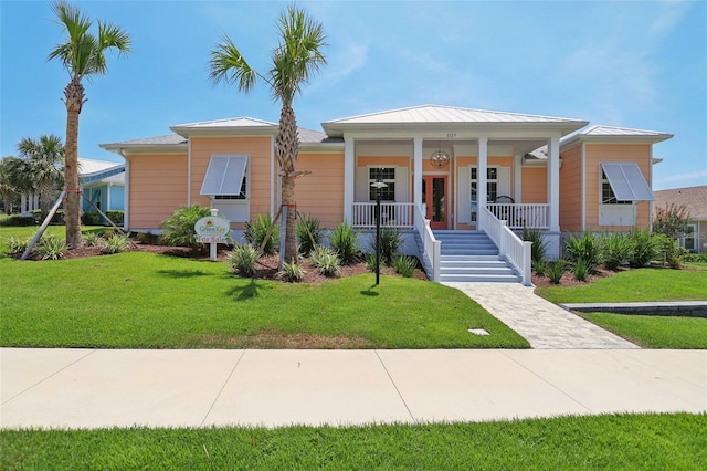 1127 Fiesta Key Cir, Lady Lake, FL 32159 - view of front facade with covered porch, a front lawn, and stairs