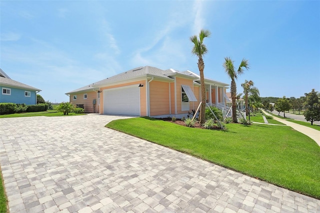 1127 Fiesta Key Cir, Lady Lake, FL 32159 - view of front of house with decorative driveway, a front yard, and an attached garage
