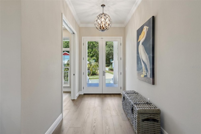 1127 Fiesta Key Cir, Lady Lake, FL 32159 - doorway to outside with french doors, a chandelier, wood finished floors, crown molding, and baseboards