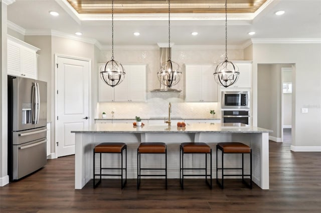 1127 Fiesta Key Cir, Lady Lake, FL 32159 - kitchen featuring stainless steel appliances, a raised ceiling, backsplash, wall chimney range hood, and white cabinets
