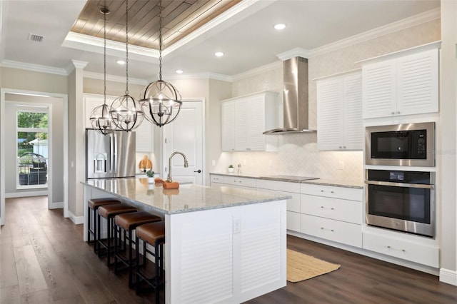 1127 Fiesta Key Cir, Lady Lake, FL 32159 - kitchen with stainless steel appliances, a sink, wall chimney exhaust hood, a chandelier, and dark wood-type flooring