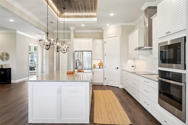 1127 Fiesta Key Cir, Lady Lake, FL 32159 - kitchen featuring appliances with stainless steel finishes, wall chimney exhaust hood, dark wood finished floors, a chandelier, and white cabinets