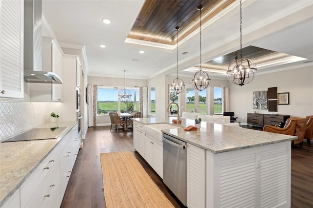 1127 Fiesta Key Cir, Lady Lake, FL 32159 - kitchen featuring stainless steel appliances, wall chimney exhaust hood, a chandelier, a tray ceiling, and a sink