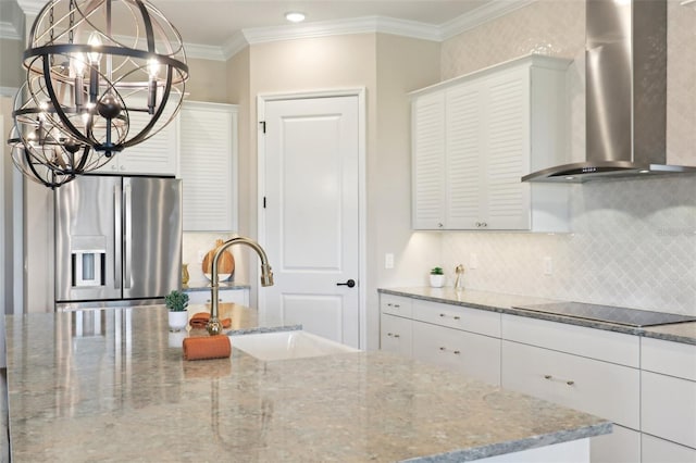 1127 Fiesta Key Cir, Lady Lake, FL 32159 - kitchen featuring wall chimney range hood, stainless steel refrigerator with ice dispenser, black electric stovetop, a sink, and decorative backsplash