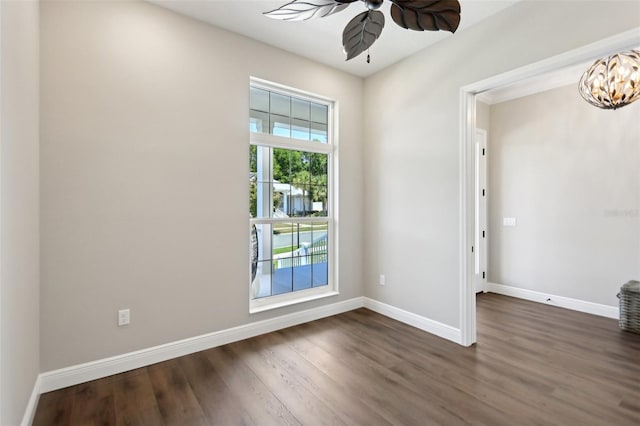 1127 Fiesta Key Cir, Lady Lake, FL 32159 - unfurnished room featuring ceiling fan, dark wood-style floors, baseboards, and a chandelier