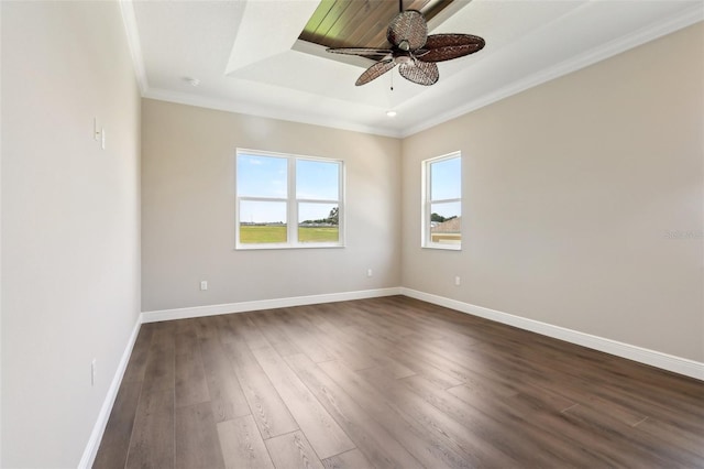 1127 Fiesta Key Cir, Lady Lake, FL 32159 - spare room with dark wood-style flooring, ceiling fan, a raised ceiling, baseboards, and crown molding