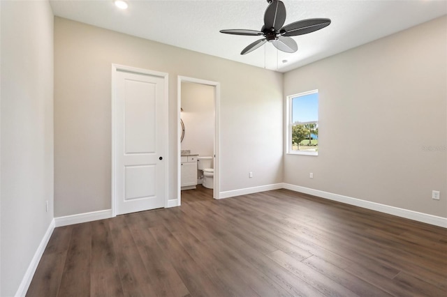 1127 Fiesta Key Cir, Lady Lake, FL 32159 - unfurnished bedroom with dark wood-style flooring, baseboards, ensuite bath, recessed lighting, and a ceiling fan