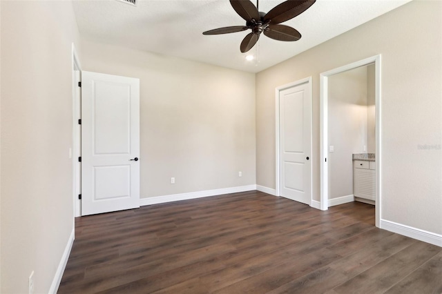 1127 Fiesta Key Cir, Lady Lake, FL 32159 - unfurnished bedroom with dark wood finished floors, baseboards, and ceiling fan