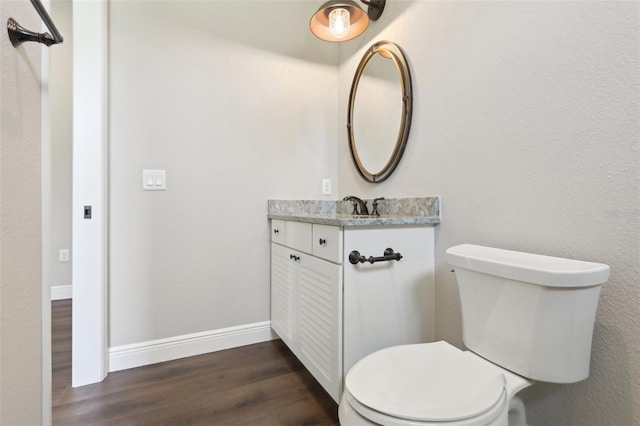 1127 Fiesta Key Cir, Lady Lake, FL 32159 - half bathroom with vanity, wood finished floors, toilet, and baseboards