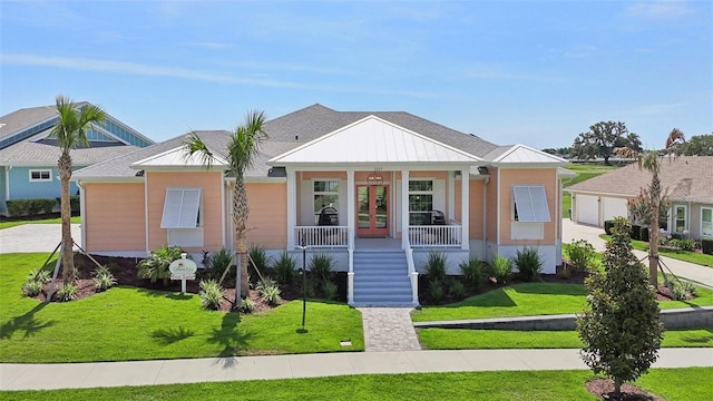 1127 Fiesta Key Cir, Lady Lake, FL 32159 - view of front facade featuring stairs, french doors, a front lawn, a porch, and a garage