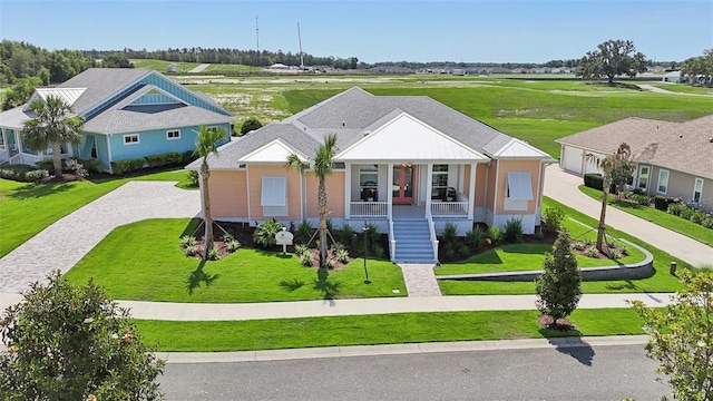 1127 Fiesta Key Cir, Lady Lake, FL 32159 - view of front facade with covered porch, decorative driveway, a front lawn, and stairway
