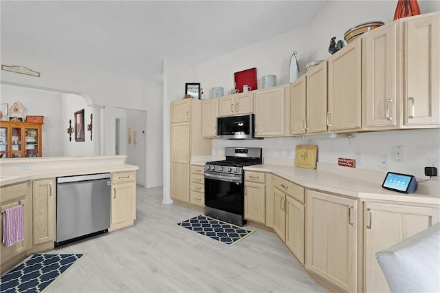 2738 Morven Park Way, The Villages, FL 32162 - kitchen featuring stainless steel appliances, light brown cabinets, light wood-style floors, light countertops, and a textured ceiling