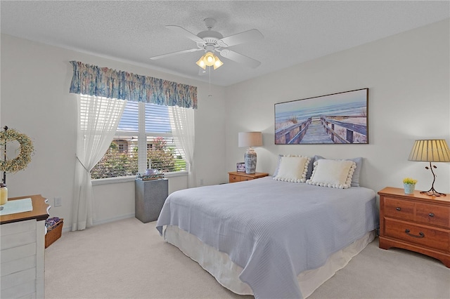 2738 Morven Park Way, The Villages, FL 32162 - bedroom with light carpet, a ceiling fan, a textured ceiling, and baseboards