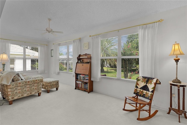 2738 Morven Park Way, The Villages, FL 32162 - living area with carpet, a textured ceiling, and a ceiling fan