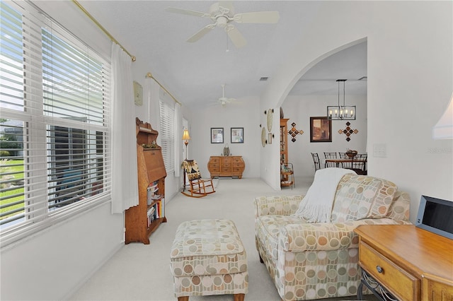 2738 Morven Park Way, The Villages, FL 32162 - carpeted living room featuring a ceiling fan, a chandelier, and arched walkways