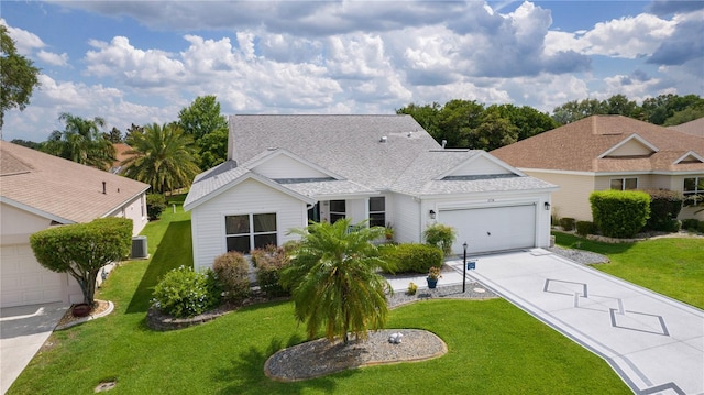 2738 Morven Park Way, The Villages, FL 32162 - view of front of property with an attached garage, driveway, a front lawn, roof with shingles, and cooling unit