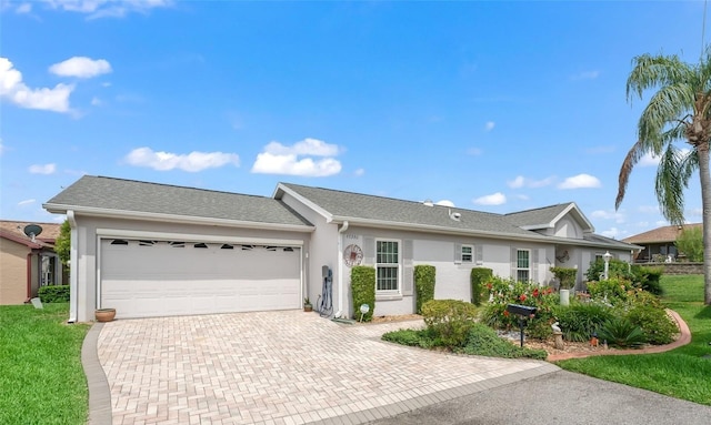 17380 SE 111th Ct, Summerfield, FL 34491 - ranch-style home featuring decorative driveway, an attached garage, stucco siding, and a front yard