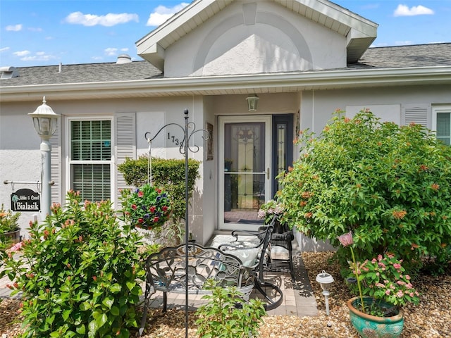 17380 SE 111th Ct, Summerfield, FL 34491 - view of exterior entry with stucco siding and roof with shingles