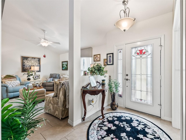17380 SE 111th Ct, Summerfield, FL 34491 - entryway featuring lofted ceiling, a ceiling fan, light tile patterned floors, and baseboards
