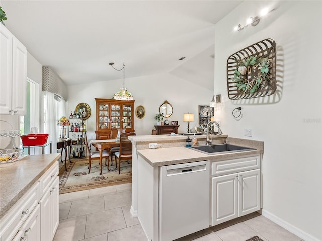17380 SE 111th Ct, Summerfield, FL 34491 - kitchen with dishwasher, a sink, white cabinets, lofted ceiling, and light countertops