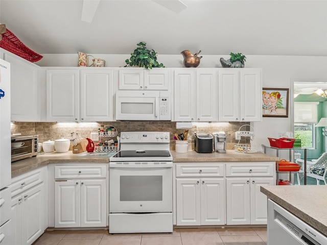 17380 SE 111th Ct, Summerfield, FL 34491 - kitchen featuring white appliances, backsplash, white cabinetry, and light countertops