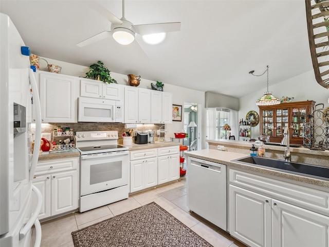 17380 SE 111th Ct, Summerfield, FL 34491 - kitchen with white appliances, a sink, backsplash, white cabinets, and light tile patterned floors