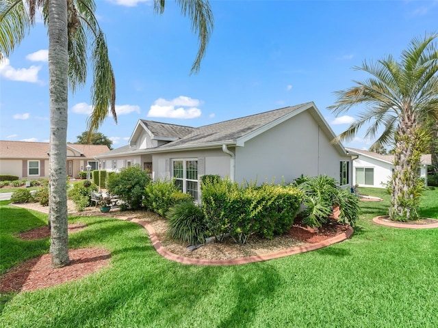 17380 SE 111th Ct, Summerfield, FL 34491 - view of property exterior with stucco siding and a yard