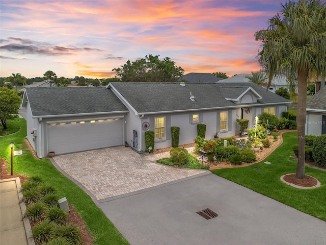 17380 SE 111th Ct, Summerfield, FL 34491 - single story home featuring driveway, a front lawn, an attached garage, roof with shingles, and stucco siding