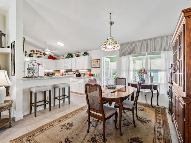 17380 SE 111th Ct, Summerfield, FL 34491 - dining room with light tile patterned flooring, vaulted ceiling, and a ceiling fan