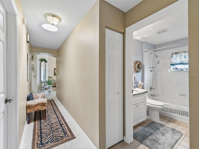 17380 SE 111th Ct, Summerfield, FL 34491 - hallway featuring light tile patterned flooring and arched walkways