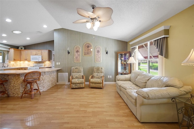 2766 Privada Dr, The Villages, FL 32162 - living area with lofted ceiling, light wood-style flooring, ceiling fan, a textured ceiling, and recessed lighting