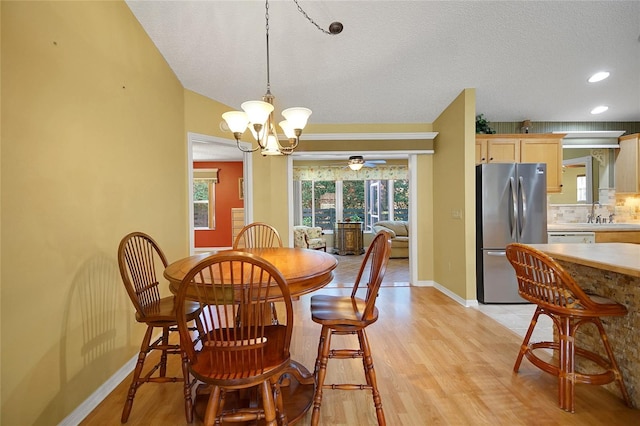 2766 Privada Dr, The Villages, FL 32162 - dining space featuring light wood finished floors, a chandelier, baseboards, a textured ceiling, and recessed lighting