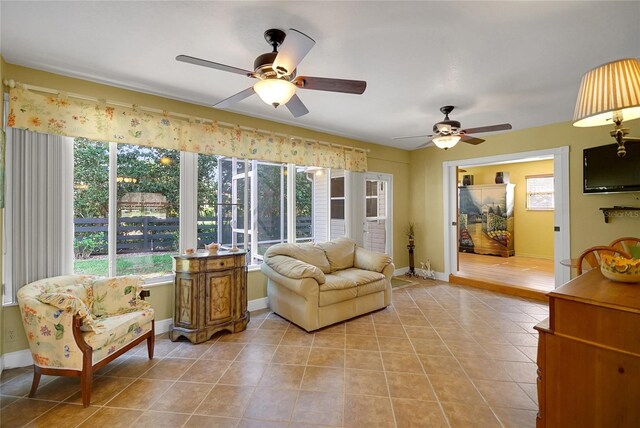 2766 Privada Dr, The Villages, FL 32162 - living room featuring ceiling fan, light tile patterned flooring, and baseboards