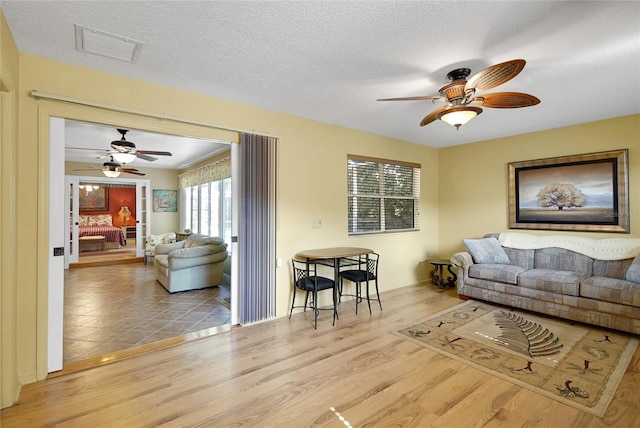 2766 Privada Dr, The Villages, FL 32162 - living room featuring a ceiling fan and wood finished floors