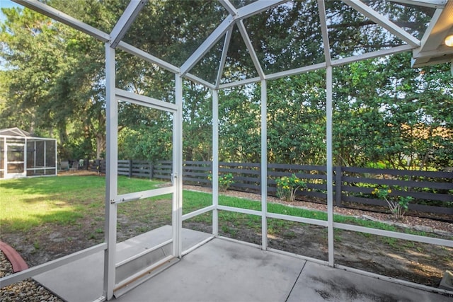 2766 Privada Dr, The Villages, FL 32162 - unfurnished sunroom featuring view of wooded area