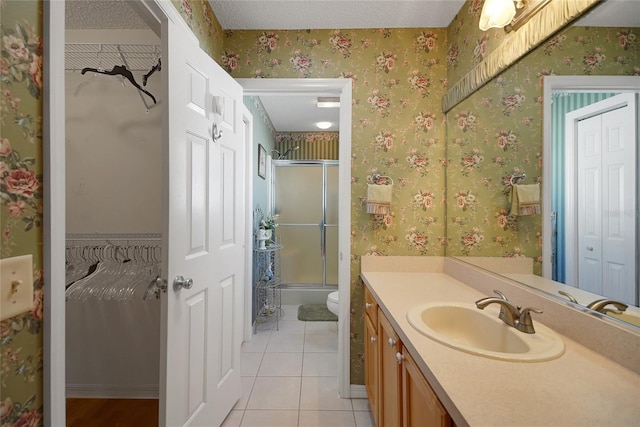 2766 Privada Dr, The Villages, FL 32162 - bathroom featuring vanity, tile patterned flooring, toilet, combined bath / shower with glass door, and wallpapered walls