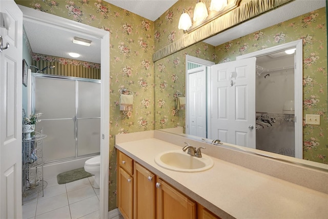 2766 Privada Dr, The Villages, FL 32162 - full bathroom featuring toilet, a shower with door, vanity, tile patterned floors, and a walk in closet