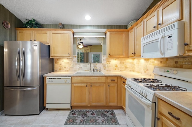 2766 Privada Dr, The Villages, FL 32162 - kitchen with white appliances, a sink, light countertops, ceiling fan, and decorative backsplash