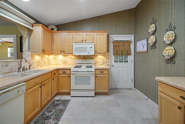 2766 Privada Dr, The Villages, FL 32162 - kitchen featuring white appliances, a sink, decorative backsplash, vaulted ceiling, and light countertops