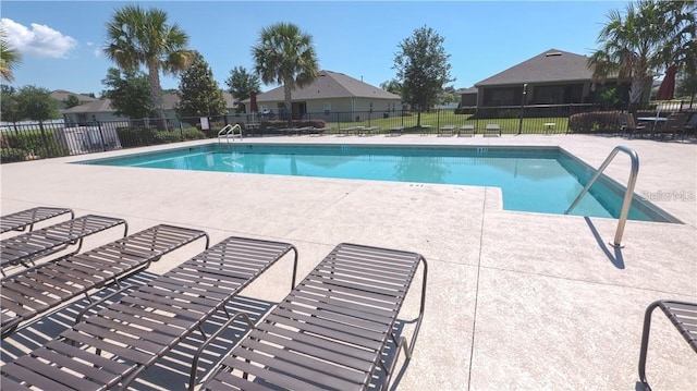 11601 Thacker Dr, Clermont, FL 34711 - community pool with a patio area and a residential view