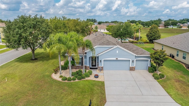 11601 Thacker Dr, Clermont, FL 34711 - view of front of property featuring a garage, concrete driveway, stucco siding, a front lawn, and stone siding