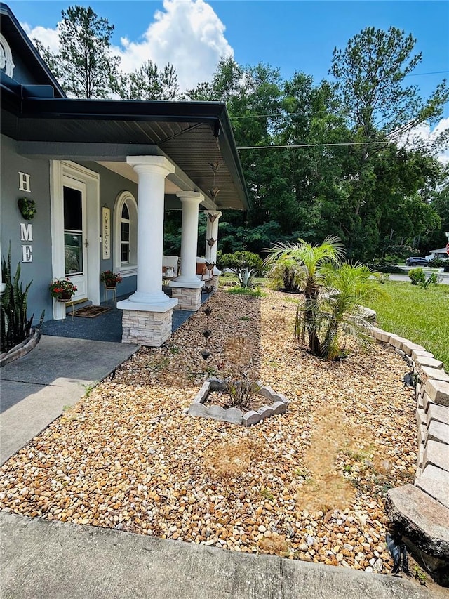 5051 NW 61st Ct, Ocala, FL 34482 - view of side of home with covered porch and stucco siding