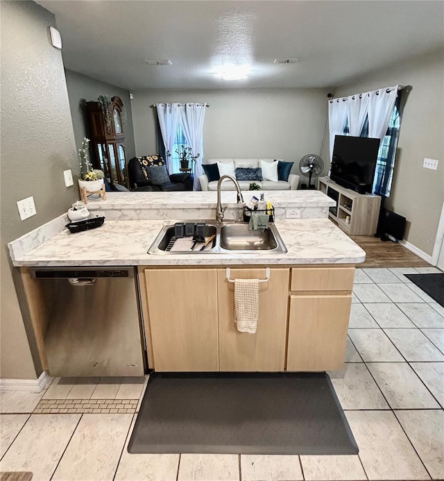 5051 NW 61st Ct, Ocala, FL 34482 - kitchen featuring dishwasher, a sink, light brown cabinetry, light countertops, and open floor plan