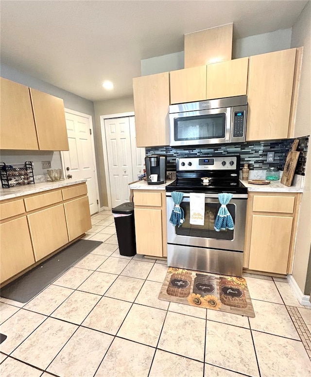 5051 NW 61st Ct, Ocala, FL 34482 - kitchen with appliances with stainless steel finishes, light brown cabinets, light countertops, light tile patterned flooring, and recessed lighting