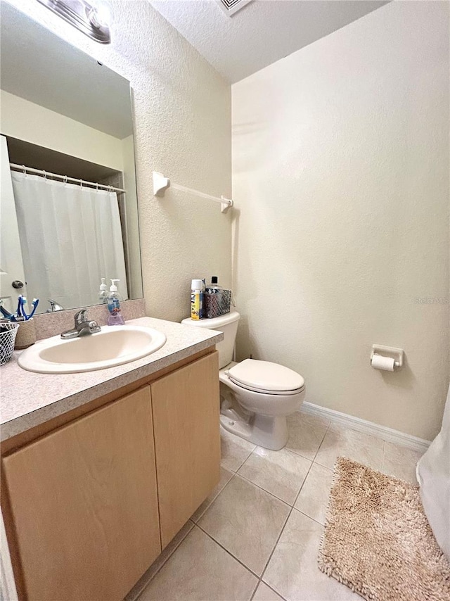 5051 NW 61st Ct, Ocala, FL 34482 - bathroom with toilet, tile patterned floors, vanity, and a textured wall