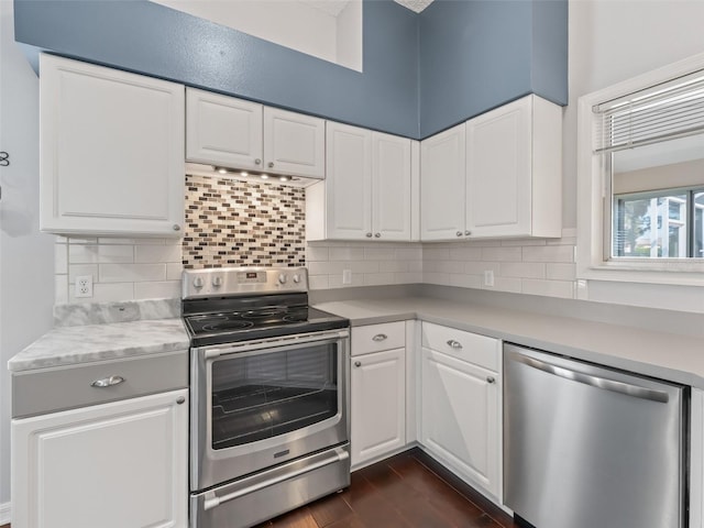628 San Pedro Dr, The Villages, FL 32159 - kitchen featuring stainless steel appliances, light countertops, tasteful backsplash, white cabinetry, and dark wood-style floors