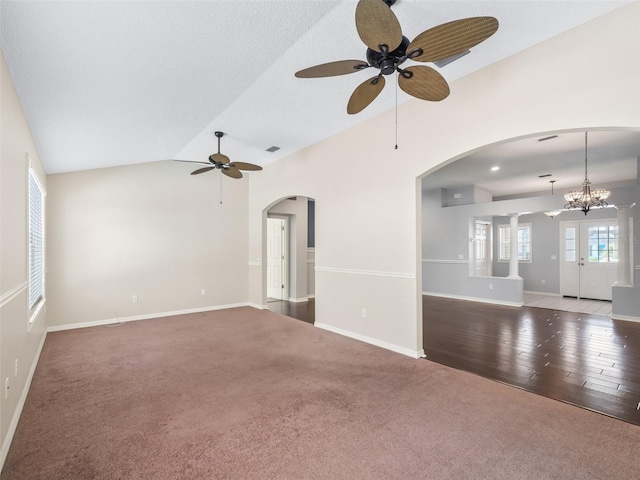 628 San Pedro Dr, The Villages, FL 32159 - unfurnished living room with ceiling fan, carpet floors, vaulted ceiling, and arched walkways