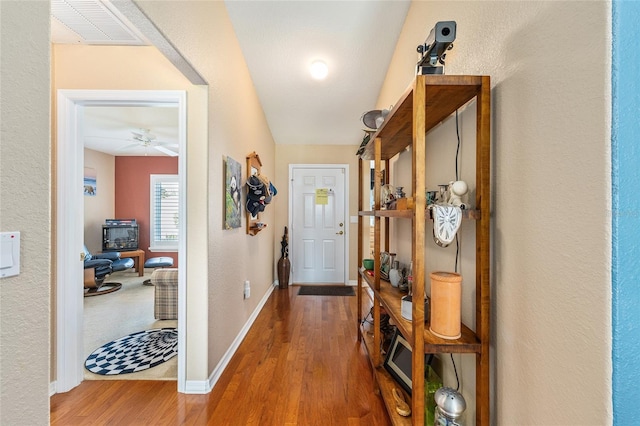 13643 SE 89th Ct, Summerfield, FL 34491 - entryway with wood finished floors, baseboards, and a wood stove