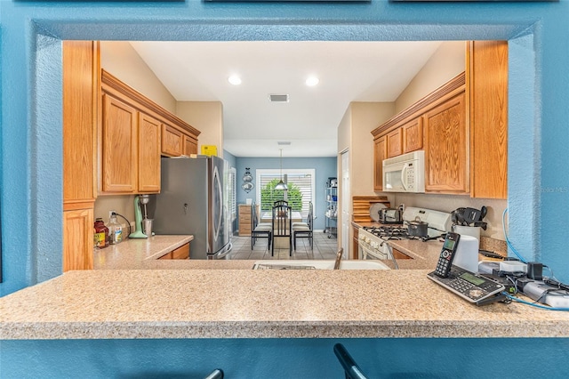 13643 SE 89th Ct, Summerfield, FL 34491 - kitchen with white appliances, light countertops, recessed lighting, and decorative light fixtures